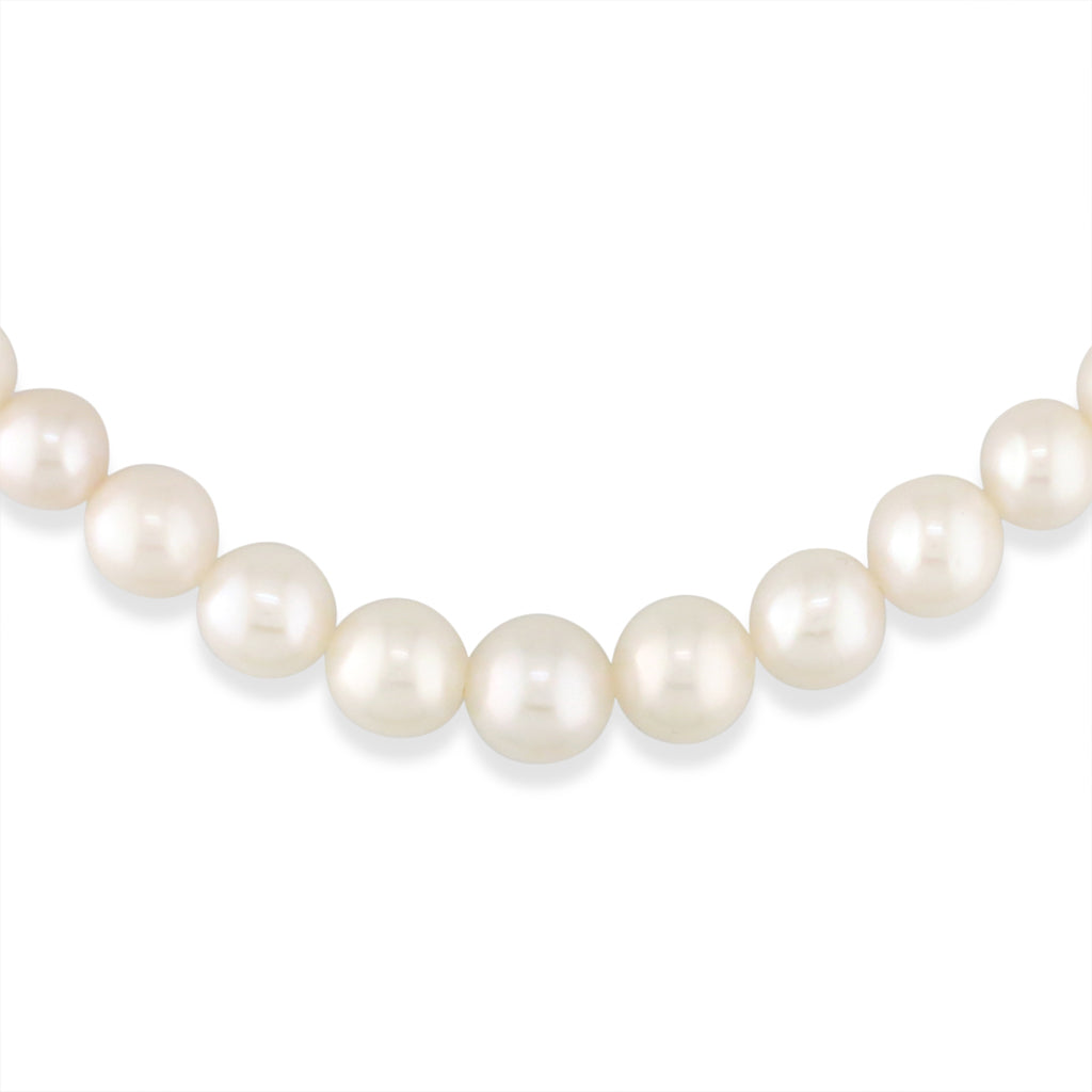 Close up shot of the graduated strand necklace showcasing white freshwater pearls ranging from 4mm to 9mm. Item no. 764531